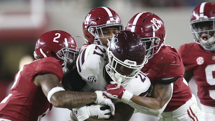 Oct 31, 2020; Tuscaloosa, Alabama, USA;  Alabama defensive back Patrick Surtain II (2), Alabama defensive back Brian Branch (14) and Alabama defensive back Malachi Moore (13) combine to tackle Mississippi State running back Jo'quavious Marks (21) at Bryant-Denny Stadium during the second half of Alabama's 41-0 win over Mississippi State. Mandatory Credit: Gary Cosby Jr/The Tuscaloosa News via Imagn Images