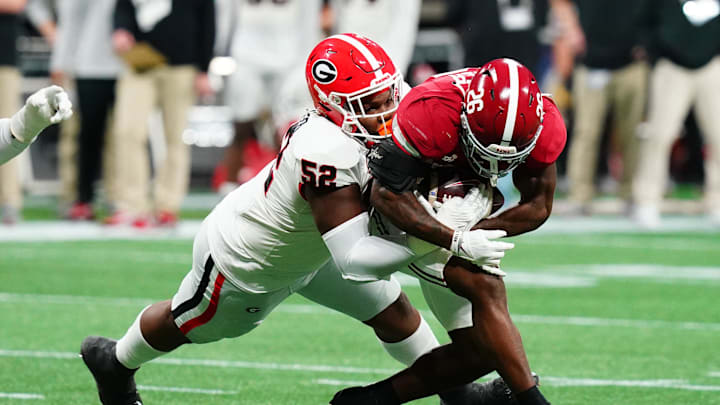 Dec 2, 2023; Atlanta, GA, USA; Georgia Bulldogs defensive lineman Christen Miller (52) tackles Alabama Crimson Tide running back Jam Miller (26) in the first quarter of the SEC Championship at Mercedes-Benz Stadium. Mandatory Credit: John David Mercer-Imagn Images