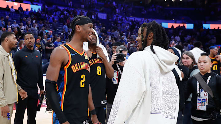 Dec 29, 2024; Oklahoma City, Oklahoma, USA;  Oklahoma City Thunder guard Shai Gilgeous-Alexander (2) and Memphis Grizzlies guard Ja Morant (12) meet after their game at Paycom Center. Mandatory Credit: Alonzo Adams-Imagn Images