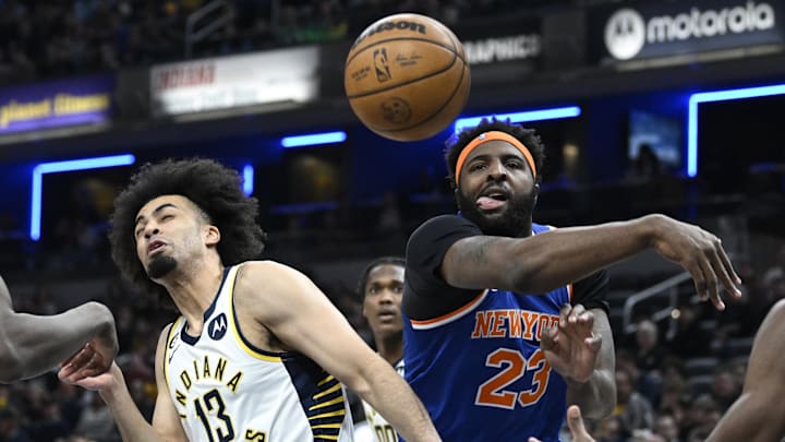 Apr 5, 2023; Indianapolis, Indiana, USA;  New York Knicks center Mitchell Robinson (23) knocks a rebound away from Indiana Pacers forward Jordan Nwora (13) during the first half at Gainbridge Fieldhouse. Mandatory Credit: Marc Lebryk-Imagn Images