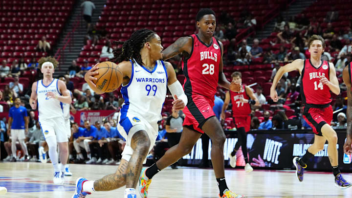 Jul 14, 2024; Las Vegas, NV, USA; Golden State Warriors guard Yuri Collins (99) dribbles around Chicago Bulls guard Chase Audige (18) during the fourth quarter at Thomas & Mack Center. Mandatory Credit: Stephen R. Sylvanie-Imagn Images