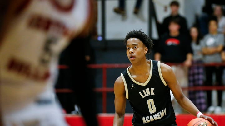 Link Academy's Tre Johnson moves the ball downcourt as the Lions took on the Central Bulldogs in The Pit at Central High School on Tuesday, Nov. 28, 2023.