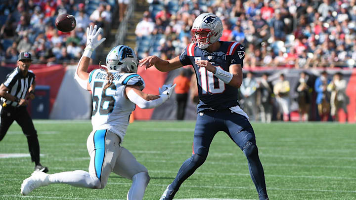 New England Patriots quarterback Drake Maye (10) passes the ball past Carolina Panthers linebacker Christian Rozeboom 