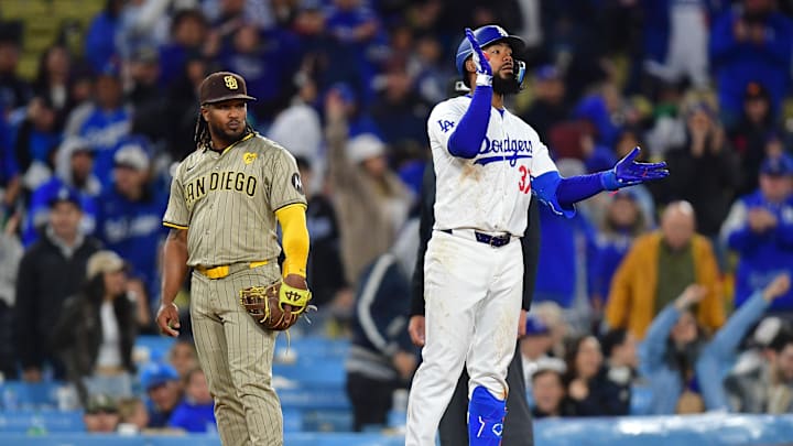 Apr 13, 2024; Los Angeles, California, USA; Los Angeles Dodgers right fielder Teoscar Hernandez (37) reaches third on an error commited by San Diego Padres right fielder Fernando Tatis Jr. (23) during the seventh inning at Dodger Stadium. Mandatory Credit: Gary A. Vasquez-Imagn Images