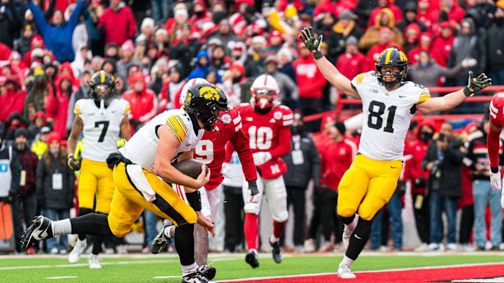 Nov 28, 2025; Lincoln, Nebraska, USA; Iowa Hawkeyes quarterback Mark Gronowski (11) scores a touchdown as tight end DJ Vonnahme (81) celebrates during the fourth quarter against the Nebraska Cornhuskers at Memorial Stadium. Mandatory Credit: Dylan Widger-Imagn Images Nov 28, 2025; Lincoln, Nebraska, USA; Iowa Hawkeyes quarterback Mark Gronowski (11) scores a touchdown as tight end DJ Vonnahme (81) celebrates during the fourth quarter against the Nebraska Cornhuskers at Memorial Stadium. Mandatory Credit: Dylan Widger-Imagn Images