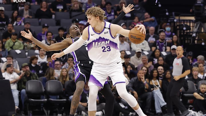 Oct 24, 2025; Sacramento, California, USA; Sacramento Kings guard Keon Ellis (23) draws an offensive foul against Utah Jazz forward Lauri Markkanen (23) during the second quarter at Golden 1 Center. Mandatory Credit: Kelley L Cox-Imagn Images