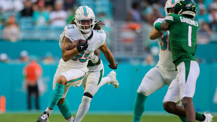 Dec 17, 2023; Miami Gardens, Florida, USA; Miami Dolphins wide receiver Chase Claypool (83) runs with the football ahead of New York Jets safety Jordan Whitehead (3) during the fourth quarter at Hard Rock Stadium. Mandatory Credit: Sam Navarro-Imagn Images