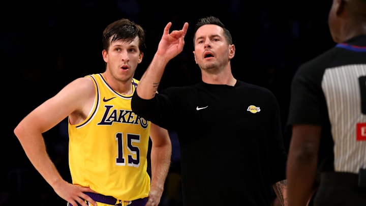 Oct 22, 2024; Los Angeles, California, USA; Los Angeles Lakers head coach JJ Redick signals a play beside guard Austin Reaves (15) during the fourth quarter against the Minnesota Timberwolves at Crypto.com Arena. Mandatory Credit: Jason Parkhurst-Imagn Images