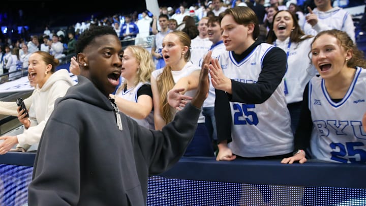 AJ Dybantsa high-fives fans at a BYU game.