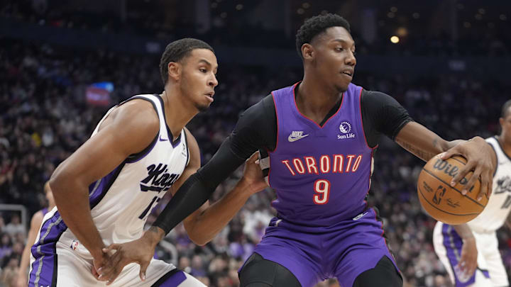 Nov 2, 2024; Toronto, Ontario, CAN; Toronto Raptors guard RJ Barrett (9) controls the ball against Sacramento Kings forward Keegan Murray (13)  during the first half at Scotiabank Arena. Mandatory Credit: John E. Sokolowski-Imagn Images