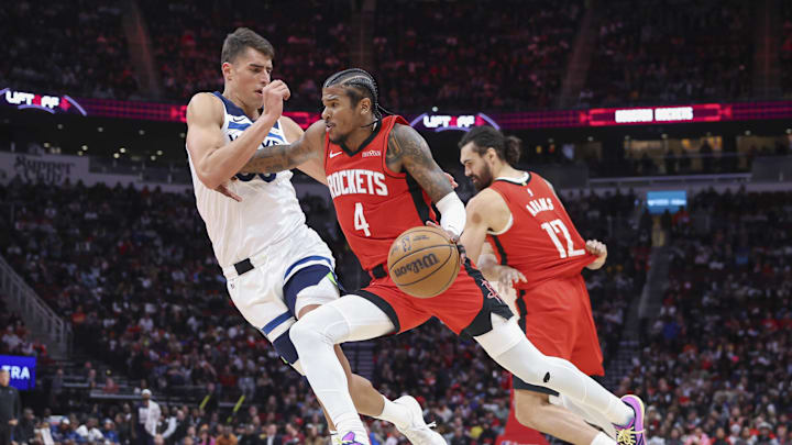 Houston Rockets guard Jalen Green dribbles the ball as Minnesota Timberwolves center Luka Garza defends.