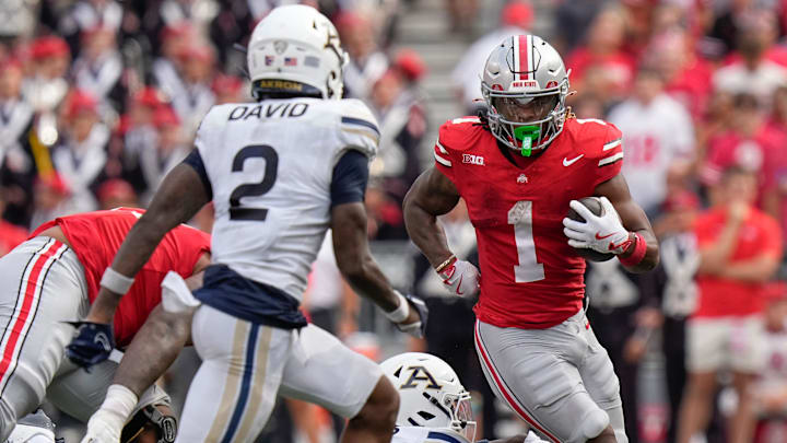 Aug 31, 2024; Columbus, OH, USA; Ohio State Buckeyes running back Quinshon Judkins (1) runs toward Akron Zips safety Daymon David (2) during the NCAA football game at Ohio Stadium. Ohio State won 52-6.