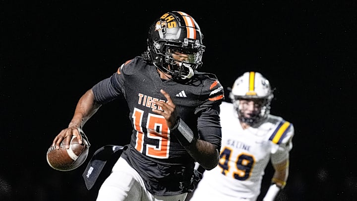 Belleville quarterback Bryce Underwood keeps the ball and runs against Saline during the second half of district final at Belleville High School in Belleville on Friday, Nov. 8, 2024.