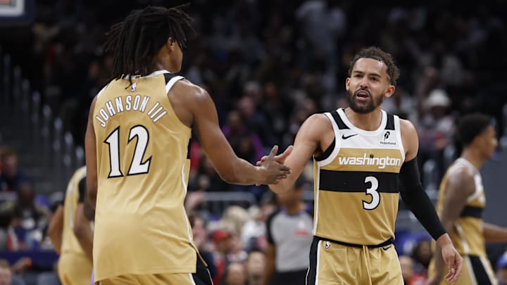 Mar 5, 2026; Washington, District of Columbia, USA; Washington Wizards guard Trae Young (3) celebrates with Wizards guard Tre Johnson (12) after a base against the Utah Jazz in the second half at Capital One Arena. Mandatory Credit: Geoff Burke-Imagn Images