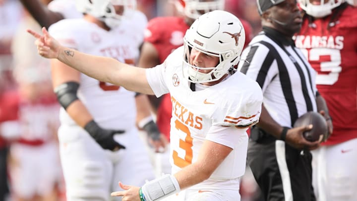 Nov 16, 2024; Fayetteville, Arkansas, USA; Texas Longhorns quarterback Quinn Ewers (3) celebrates after making a final first down to end the game against the Arkansas Razorbacks at Donald W. Reynolds Razorback Stadium. Texas won 20-10. Mandatory Credit: Nelson Chenault-Imagn Images