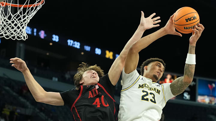 Nov 24, 2025; Las Vegas, Nevada, USA; Michigan Wolverines forward Yaxel Lendeborg (23) reaches for a rebound against San Diego State Aztecs forward Miles Heide (40).