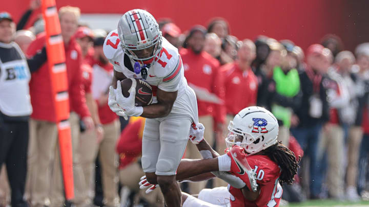 Nov 4, 2023; Piscataway, New Jersey, USA; Ohio State Buckeyes wide receiver Carnell Tate (17) breaks a tackle against Rutgers Scarlet Knights defensive back Flip Dixon (10) during the second half at SHI Stadium. Mandatory Credit: Vincent Carchietta-USA TODAY Sports