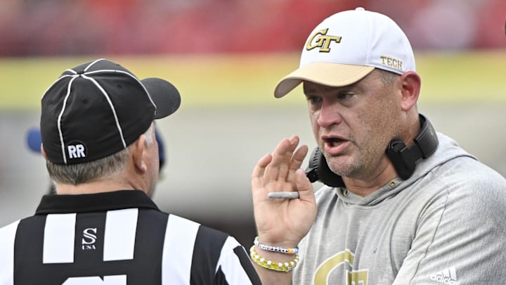 Sep 21, 2024; Louisville, Kentucky, USA;  Georgia Tech Yellow Jackets head coach Brent Key talks with an official during the second half against the Louisville Cardinals at L&N Federal Credit Union Stadium. Mandatory Credit: Jamie Rhodes-Imagn Images