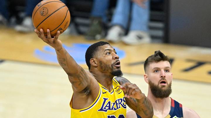 Jan 28, 2026; Cleveland, Ohio, USA; Los Angeles Lakers guard Marcus Smart (36) drives to the basket beside Cleveland Cavaliers forward Dean Wade (32) in the second quarter at Rocket Arena. Mandatory Credit: David Richard-Imagn Images