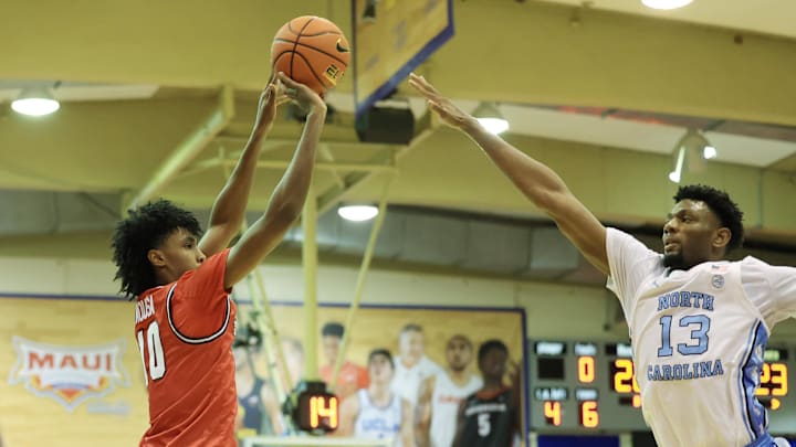 Nov 25, 2024; Lahaina, Hawaii, USA;  Dayton Flyers guard Hamad Mousa (10) attempts a three pointer over North Carolina Tar Heels forward Jalen Washington (13) during the first half of an NCAA college basketball game at Lahaina Civic Center. Mandatory Credit: Marco Garcia-Imagn Images