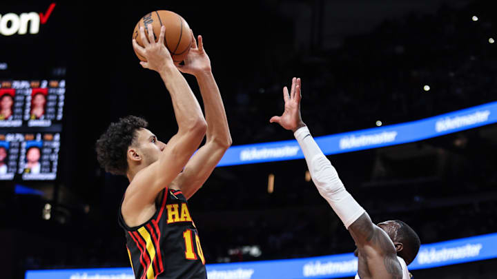 Feb 23, 2025; Atlanta, Georgia, USA; Atlanta Hawks forward Zaccharie Risacher (10) shoots the ball over Detroit Pistons guard Dennis Schroder (17) during the fourth quarter at State Farm Arena. Mandatory Credit: Jordan Godfree-Imagn Images