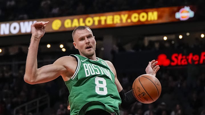 Mar 28, 2024; Atlanta, Georgia, USA; Boston Celtics center Kristaps Porzingis (8) dunks against the Atlanta Hawks during the first half at State Farm Arena. Mandatory Credit: Dale Zanine-Imagn Images