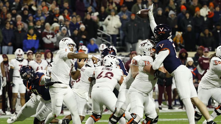 Nov 29, 2025; Charlottesville, Va.; Virginia defensive end Fisher Camac (14) tips a pass by Virginia Tech quarterback Kyron Drones (1) resulting in an interception. Nov 29, 2025; Charlottesville, Va.; Virginia defensive end Fisher Camac (14) tips a pass by Virginia Tech quarterback Kyron Drones (1) resulting in an interception.