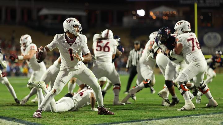 Nov 29, 2025; Charlottesville, Va.; Virginia Tech quarterback Kyron Drones (1) passes the ball from his own end zone against Virginia. Nov 29, 2025; Charlottesville, Va.; Virginia Tech quarterback Kyron Drones (1) passes the ball from his own end zone against Virginia.