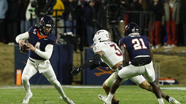 Nov 29, 2025; Charlottesville, Virginia, USA; Virginia Cavaliers quarterback Chandler Morris (4) scrambles from Virginia Tech Hokies linebacker Kaleb Spencer (3) in the second quarter at Scott Stadium. Mandatory Credit: Geoff Burke-Imagn Images