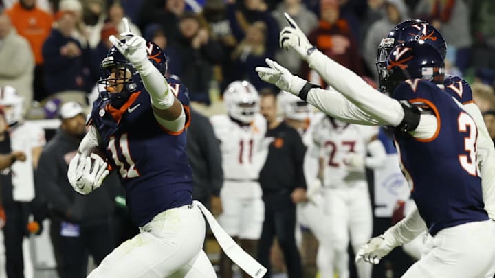 Nov 29, 2025; Charlottesville, Virginia, USA; Virginia Cavaliers linebacker Maddox Marcellus (11) celebrates after intercepting a pass against the Virginia Tech Hokies in the first quarter at Scott Stadium. Mandatory Credit: Geoff Burke-Imagn Images Nov 29, 2025; Charlottesville, Virginia, USA; Virginia Cavaliers linebacker Maddox Marcellus (11) celebrates after intercepting a pass against the Virginia Tech Hokies in the first quarter at Scott Stadium. Mandatory Credit: Geoff Burke-Imagn Images