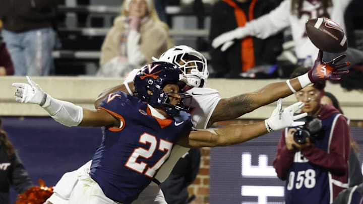 Nov 29, 2025; Charlottesville, Virginia, USA; Virginia Tech Hokies tight end Ja'Ricous Hairston (13) attempts to catch a pass as Virginia Cavaliers safety Devin Neal (27) defendds in the first quarter at Scott Stadium. Mandatory Credit: Geoff Burke-Imagn Images