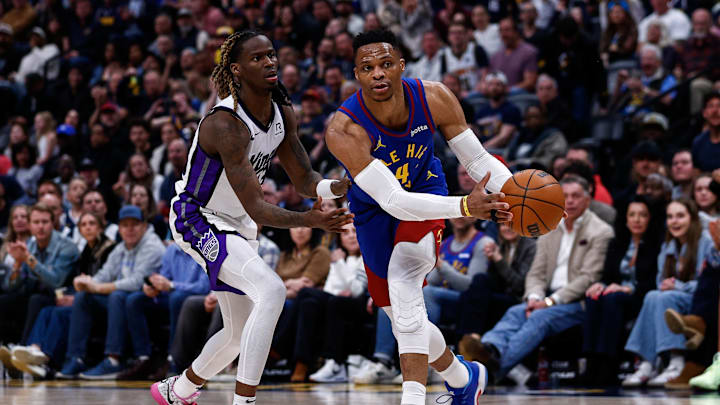 Mar 5, 2025; Denver, Colorado, USA; Denver Nuggets guard Russell Westbrook (4) controls the ball as Sacramento Kings guard Keon Ellis (23) guards in the fourth quarter at Ball Arena. Mandatory Credit: Isaiah J. Downing-Imagn Images