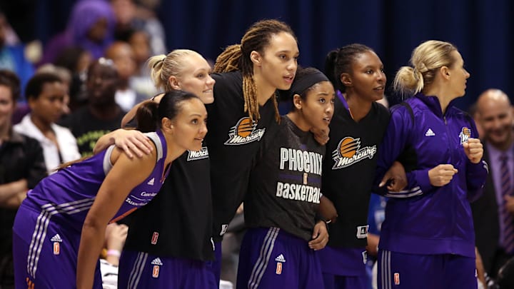 Sep 12, 2014; Chicago, IL, USA; Phoenix Mercury center Brittney Griner (middle) and teammates link arms as they watch during the fourth quarter against the Chicago Sky in game three of the 2014 WNBA Finals at UIC Pavilion. Mandatory Credit: Jerry Lai-Imagn Images