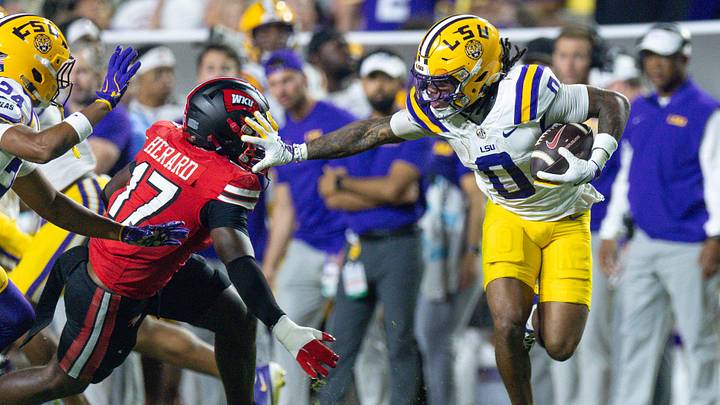 Nov 22, 2025; Baton Rouge, Louisiana, USA; LSU Tigers wide receiver Zavion Thomas (0) pushes away Western Kentucky Hilltoppers defensive back Dave Herard (17) during the second half at Tiger Stadium. Mandatory Credit: Stephen Lew-Imagn Images Nov 22, 2025; Baton Rouge, Louisiana, USA; LSU Tigers wide receiver Zavion Thomas (0) pushes away Western Kentucky Hilltoppers defensive back Dave Herard (17) during the second half at Tiger Stadium. Mandatory Credit: Stephen Lew-Imagn Images