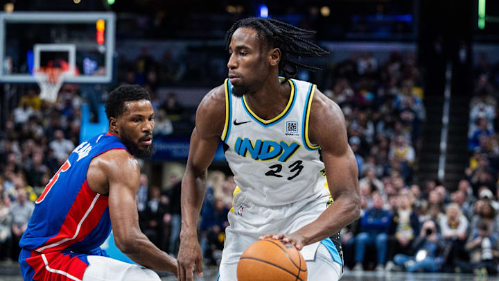 Jan 29, 2025; Indianapolis, Indiana, USA; Indiana Pacers forward Aaron Nesmith (23) dribbles the ball while Detroit Pistons guard Malik Beasley (5) defends in the first half at Gainbridge Fieldhouse. Mandatory Credit: Trevor Ruszkowski-Imagn Images