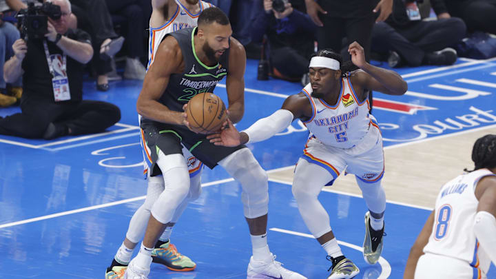May 20, 2025; Oklahoma City, Oklahoma, USA; Minnesota Timberwolves center Rudy Gobert (27) and Oklahoma City Thunder guard Luguentz Dort (5) fight for a rebound during the first quarter in game one of the western conference finals for the 2025 NBA Playoffs at Paycom Center. Mandatory Credit: Alonzo Adams-Imagn Images May 20, 2025; Oklahoma City, Oklahoma, USA; Minnesota Timberwolves center Rudy Gobert (27) and Oklahoma City Thunder guard Luguentz Dort (5) fight for a rebound during the first quarter in game one of the western conference finals for the 2025 NBA Playoffs at Paycom Center. Mandatory Credit: Alonzo Adams-Imagn Images