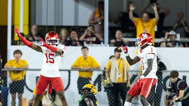 Oct 25, 2025; Tempe, Arizona, USA; Houston Cougars defensive back Will James (15) and Latrell McCutchin Sr. (1) celebrate after breaking up a pass intended for Arizona State Sun Devils wide receiver Jaren Hamilton (16) in the second half at Mountain America Stadium. Mandatory Credit: Mark J. Rebilas-Imagn Images
