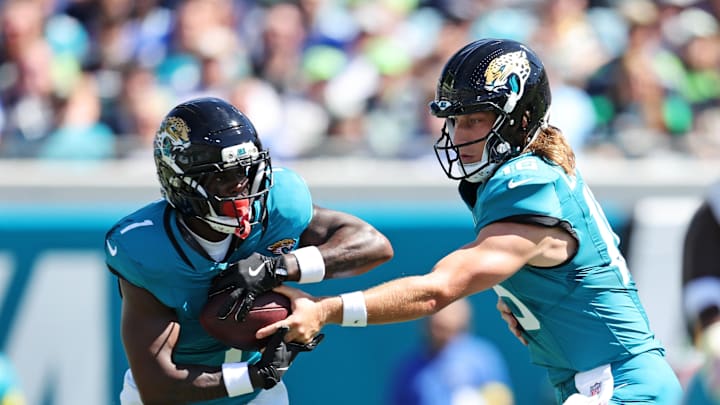 Oct 12, 2025; Jacksonville, Florida, USA; Jacksonville Jaguars quarterback Trevor Lawrence (16) hands off to Jacksonville Jaguars running back Travis Etienne (1) during the first half against the Seattle Seahawks at EverBank Stadium. Mandatory Credit: Morgan Tencza-Imagn Images