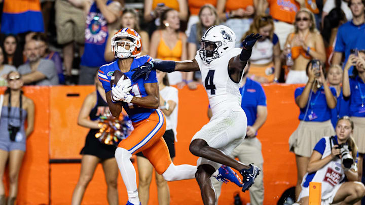 Sep 7, 2024; Gainesville, Florida, USA; Florida Gators wide receiver Aidan Mizell (11) makes a catch over Samford Bulldogs cornerback Xavier Lanier (4) during the second half at Ben Hill Griffin Stadium. Mandatory Credit: Matt Pendleton-Imagn Images
