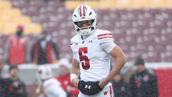 Nov 29, 2025; Minneapolis, Minnesota, USA; Wisconsin Badgers quarterback Carter Smith (5) warms up before the game against the Minnesota Golden Gophers at Huntington Bank Stadium. 