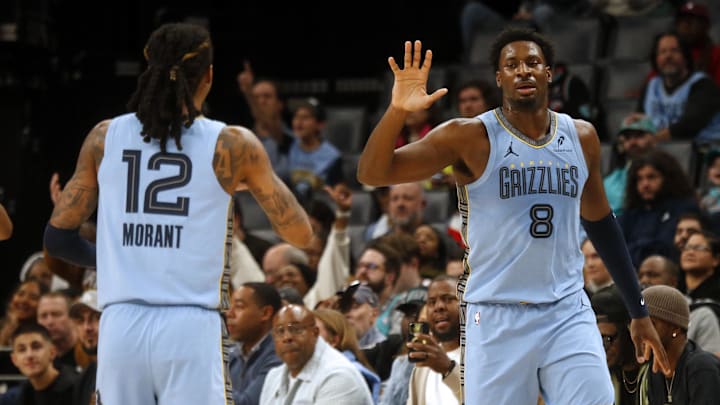 Jan 21, 2026; Memphis, Tennessee, USA; Memphis Grizzlies forward/center Jaren Jackson Jr. (8) reacts with guard Ja Morant (12) during the first quarter against the Atlanta Hawks at FedExForum. Mandatory Credit: Petre Thomas-Imagn Images