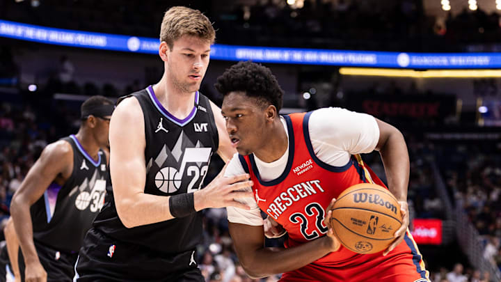 Apr 7, 2026; New Orleans, Louisiana, USA; Utah Jazz center Kyle Filipowski (22) defends against New Orleans Pelicans center Derik Queen (22) during the first half at Smoothie King Center. Mandatory Credit: Stephen Lew-Imagn Images