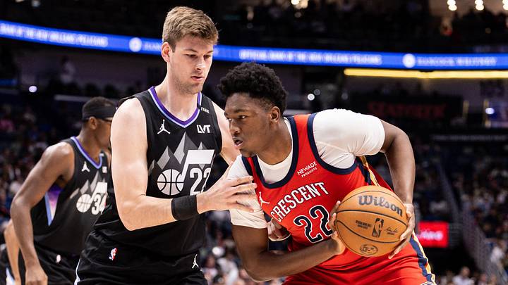 Apr 7, 2026; New Orleans, Louisiana, USA; Utah Jazz center Kyle Filipowski (22) defends against New Orleans Pelicans center Derik Queen (22) during the first half at Smoothie King Center. Mandatory Credit: Stephen Lew-Imagn Images