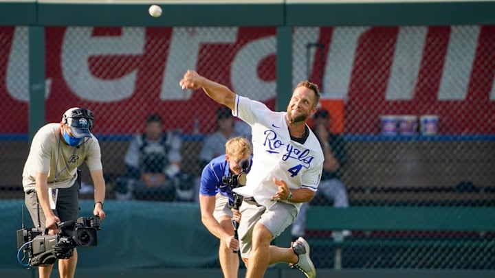 Jul 24, 2021; Kansas City, Missouri, USA;  Former Kansas City Royals left fielder Alex Gordon throws to home plate from left field during Alex Gordon Day ceremonies before the game against the Detroit Tigers at Kauffman Stadium. Mandatory Credit: Denny Medley-Imagn Images