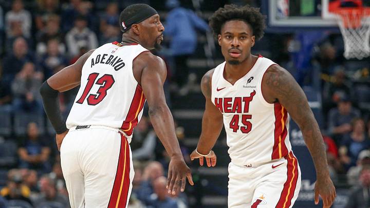 Oct 24, 2025; Memphis, Tennessee, USA; Miami Heat center Bam Adebayo (13) reacts with guard Davion Mitchell (45) during the first quarter against the Memphis Grizzlies at FedExForum. Mandatory Credit: Petre Thomas-Imagn Images
