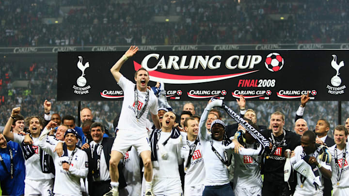 Spurs players celebrate winning the trophy 