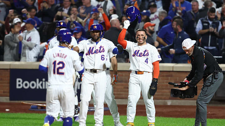 Oct 9, 2024; New York, New York, USA; New York Mets shortstop Francisco Lindor (12) celebrates a grand slam with Mets outfielder Starling Marte (6) and Mets catcher Francisco Alvarez (4) in the sixth inning against the Philadelphia Phillies in game four of the NLDS for the 2024 MLB Playoffs at Citi Field. Mandatory Credit: Wendell Cruz-Imagn Images