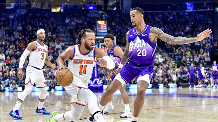 Nov 23, 2024; Salt Lake City, Utah, USA; New York Knicks guard Jalen Brunson (11) dribbles the ball against Utah Jazz forward/center John Collins (20) during the first half at the Delta Center. Mandatory Credit: Christopher Creveling-Imagn Images
