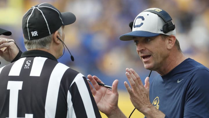 Cal head coach Justin Wilcox talks to line judge Peter Beratta during Saturday's game at Pitt