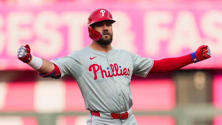 Philadelphia Phillies designated hitter Kyle Schwarber (12) gestures to the dugout after hitting a double during the first inning against the Kansas City Royals at Kauffman Stadium.